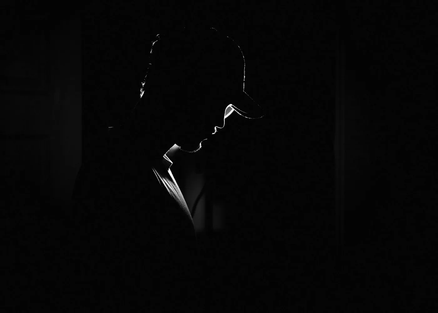 Silhouette of a figure in a low-lit interior