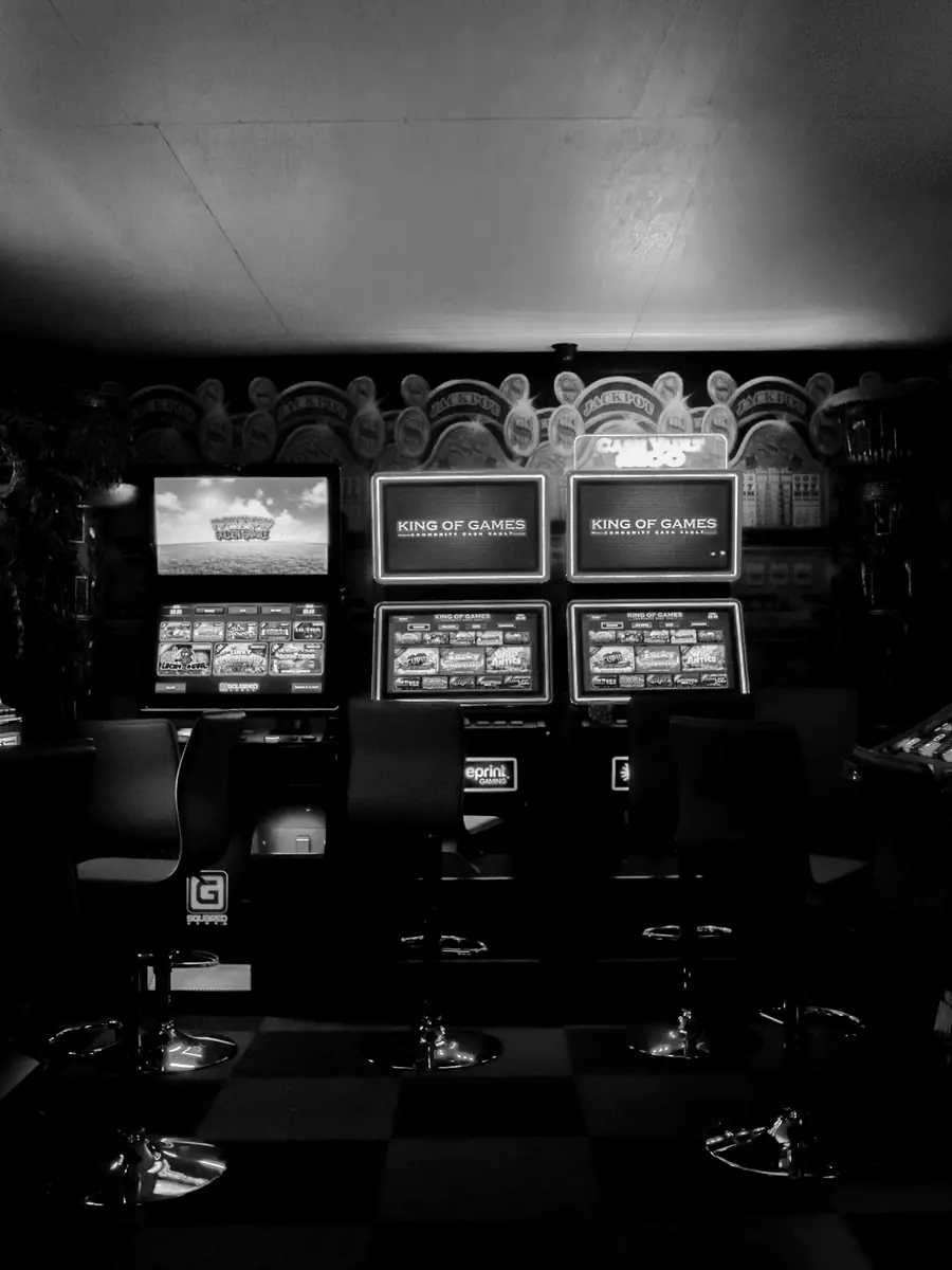 A dim room lined with arcade machines